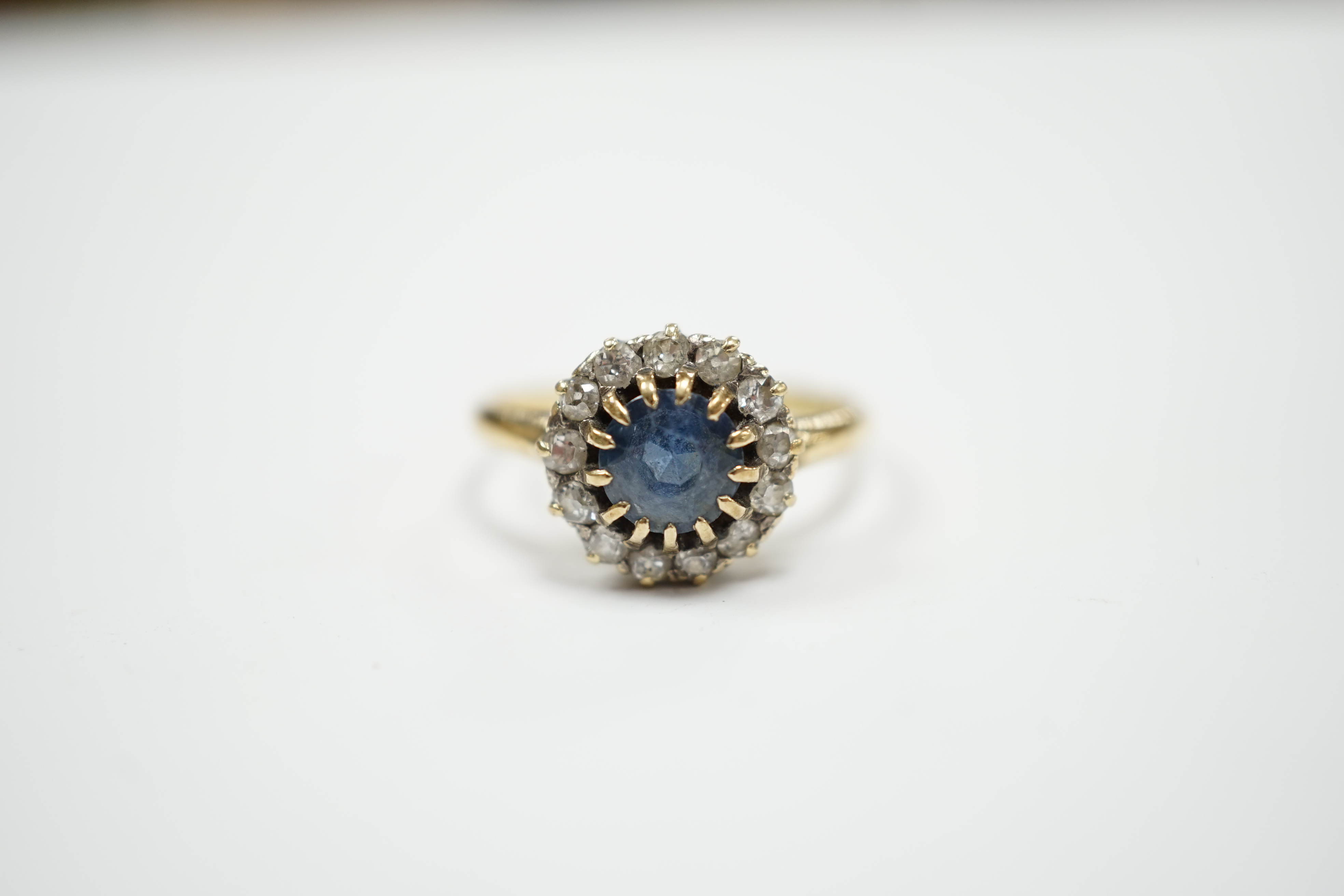 An early 20th century 18ct, sapphire and diamond set circular cluster ring, size P, gross weight 3.3 grams.